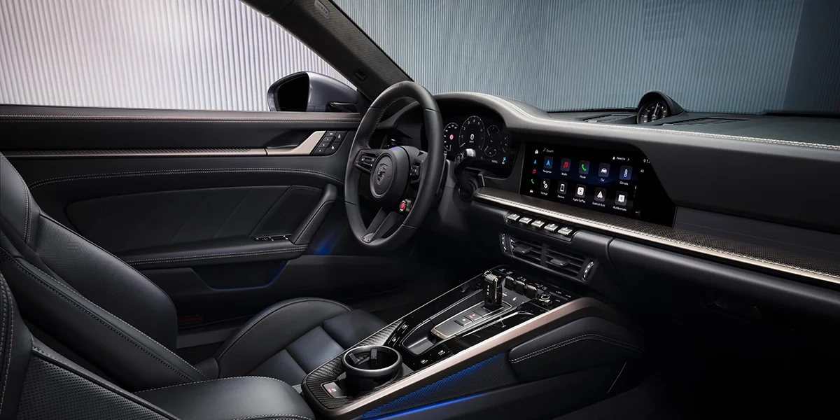 2026 Porsche 911 Turbo S luxury interior with premium leather seats, digital driver display, touchscreen infotainment, and carbon fiber accents.